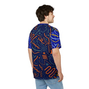 Man wearing a blue t-shirt with colorful geometric patterns on a white background